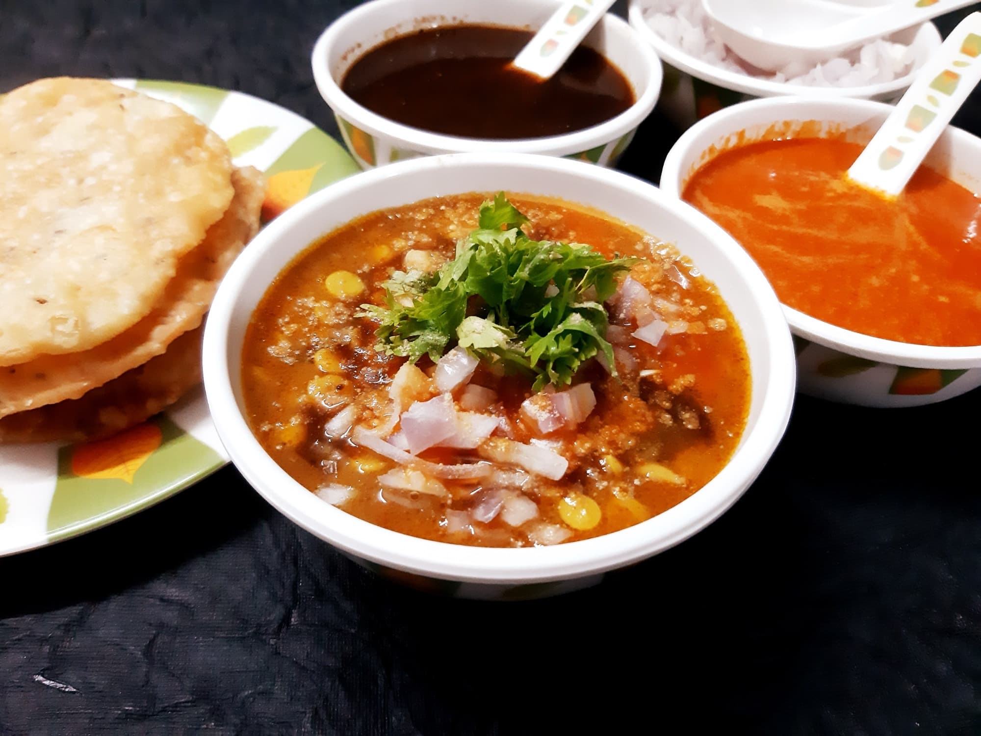 Sindhi dal pakwan: chana dal with onions, crisp pakwan, and chutneys